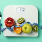 Weight loss or healthy lifestyle accessories on mint background