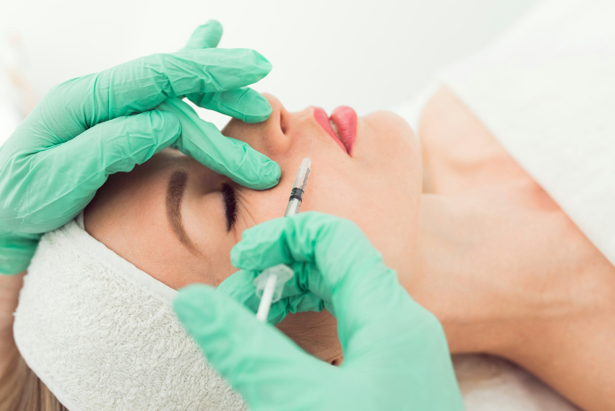 woman gets cosmetic injection of botox in a clinic